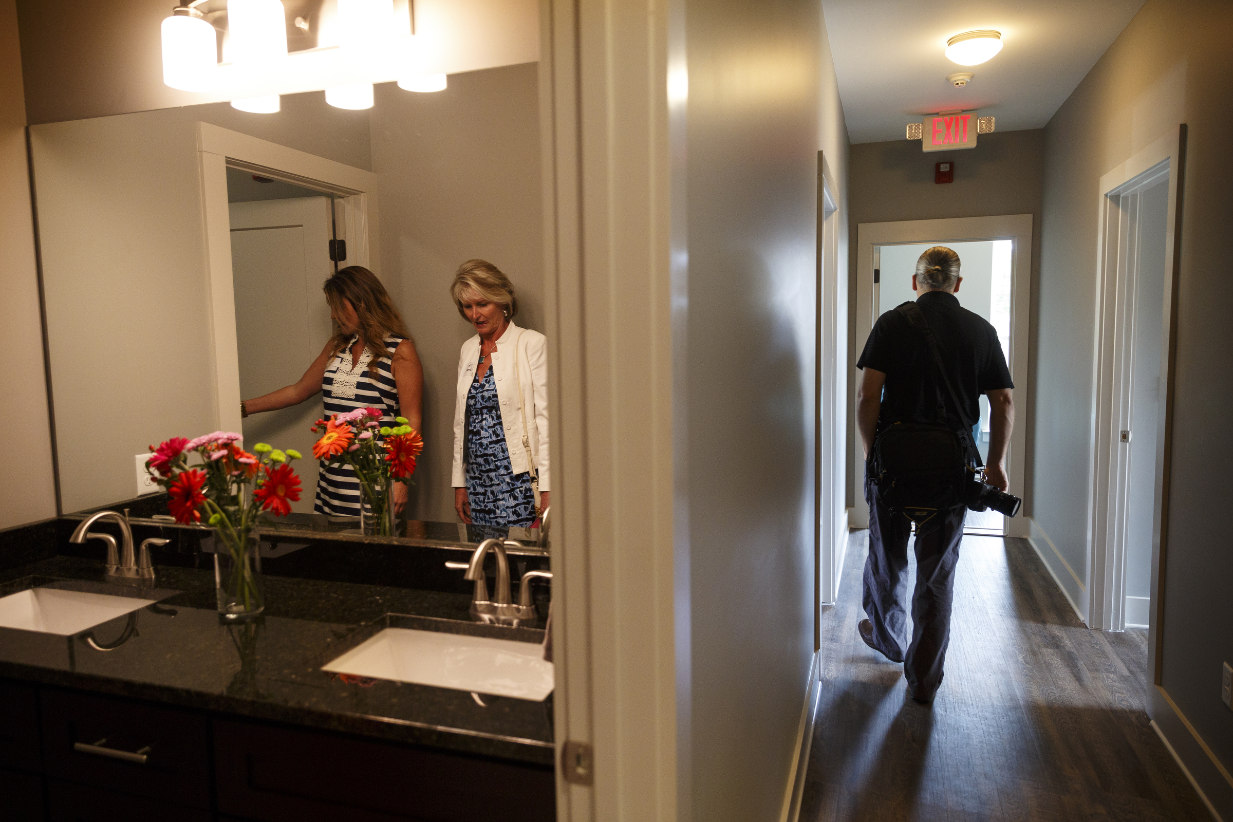 Robyn Graves, left, gives Ute Strand a tour at a ribbon-cutting for Bailey Home, a new residence facility for people with mental disabilities, on Tuesday, June 21, 2016, in Chattanooga, Tenn. The co-ed facility set up by Helen Ross McNabb Center will house 10 residents.