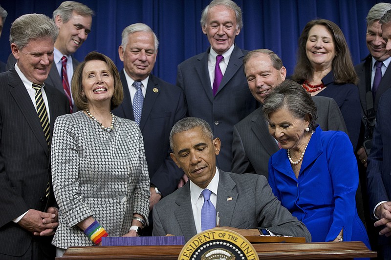 
              President Barack Obama, surrounded by members of Congress, signs bill H.R. 2576, the Frank R. Lautenberg Chemical Safety for the 21st Century Act., Wednesday, June 22, 2016, during a ceremony at the Eisenhower Executive Office Building on the White House complex in Washington. (AP Photo/Pablo Martinez Monsivais)
            