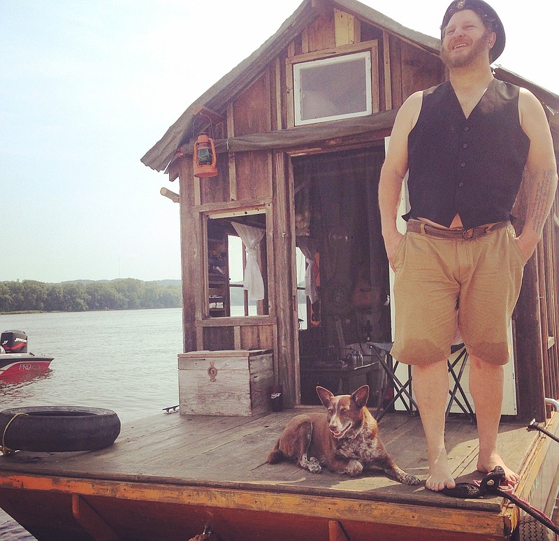 Wes Modes and his dog Hazel aboard his self-constructed shantyboat. (Photo by Wes Modes)