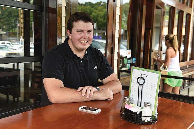 Andrew Byrum, a 2015 graduate of UTC's entrepreneurship program, sits at a table at Taco Mamacita. Byrum's startup, Get Seated, is a phone app that updates patrons on wait times at restaurants.