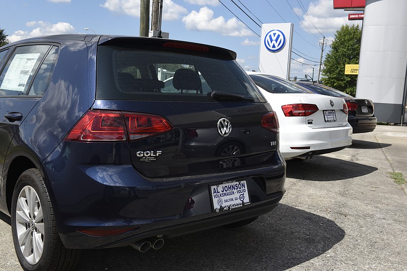 A diesel Golf, left, and a diesel Passat, right, are displayed on either side of a gasoline-powered Jetta in front of the Al Johnson Volkswagen Volvo dealership on Tuesday, Sept. 22, 2015, in Dalton, Ga.