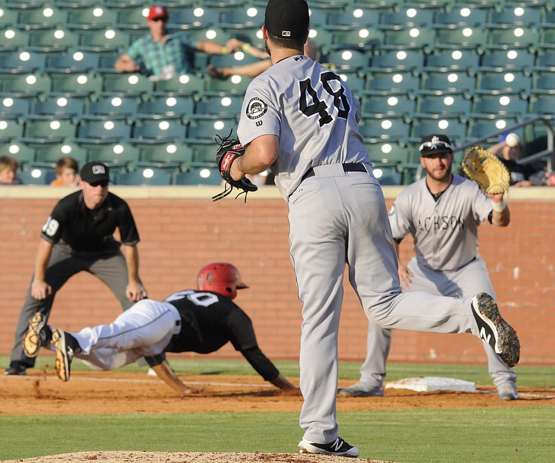 D.J. Peterson awaits the throw as Leonardo Reginatto, left, dives to avoid the pick by Jackson Generals pitcher Jordan Pries Thursday night game at AT&T Field.