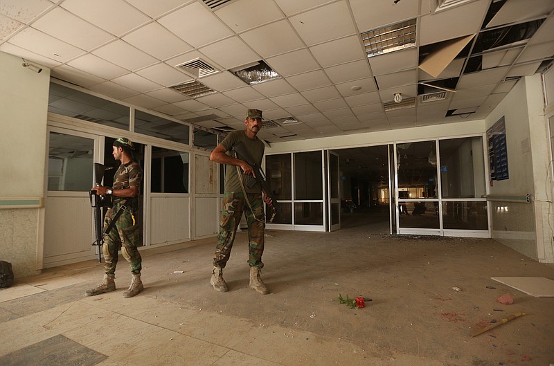 
              Iraqi soldiers inspect the hospital in Fallujah, Iraq, Wednesday, June 22, 2016. Pockets of Islamic State fighters continue to hold neighborhoods along the north and west of the city. (AP Photo/Hadi Mizban)
            