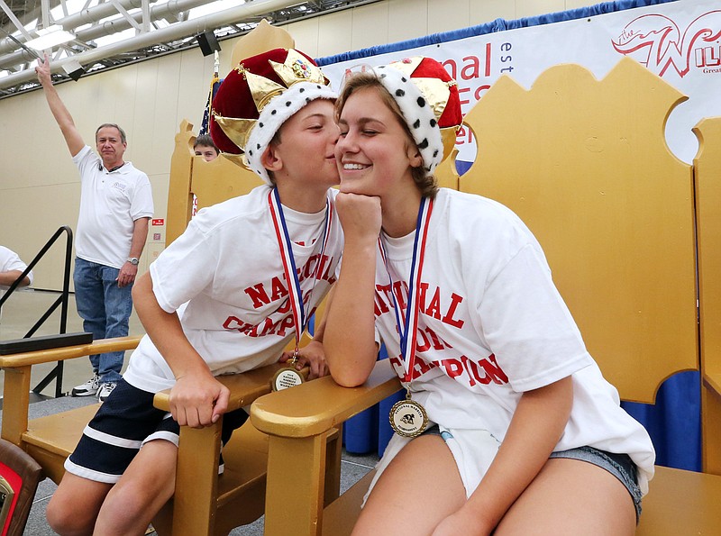 
              National Marbles boys champion Louis Lee 11, of Glade Park Colo., left, gives girls champion Haley Grenesko 13, of Pittsburgh,  the traditional kiss on the cheek, during the awards ceremony after the final matches, Thursday, June 23, 2016, at the 93rd annual National Marbles Championship Tournament in Wildwood, N.J. (Dale Gerhard/The Press of Atlantic City via AP) MANDATORY CREDIT
            