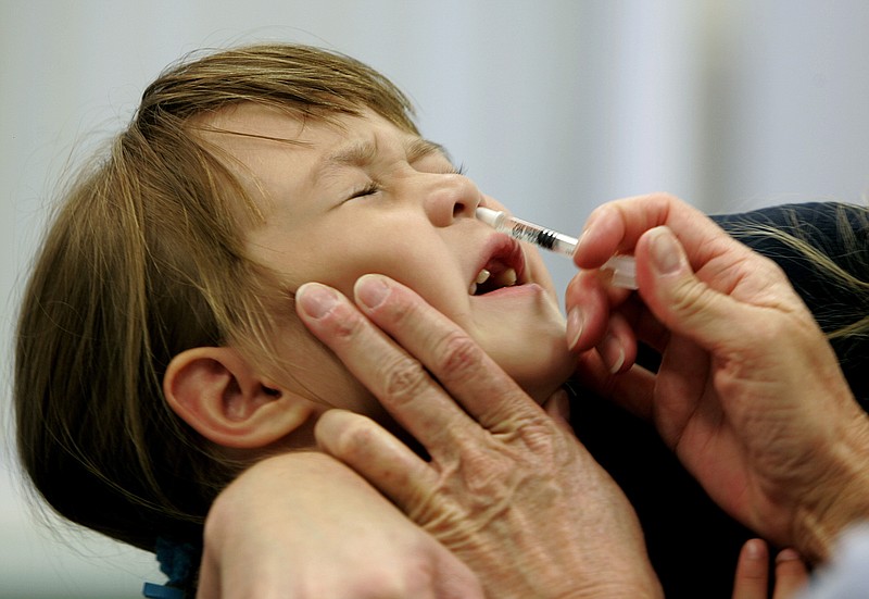 In this Oct. 4, 2005, file photo, a Danielle Holland reacts as she is given a FluMist influenza vaccination in St. Leonard, Md.