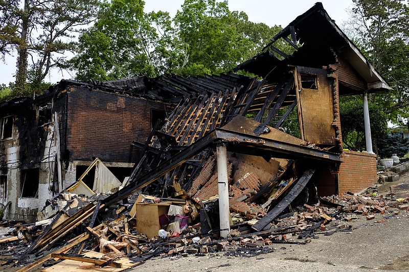 The collapsed structure of a burned home remains Friday, June 24, 2016, after an overnight house fire on Bitsy Lane left one man dead in Red Bank. Spokesperson Amy Maxwell said the Red Bank Fire Department responded to the fire at about 12:30 a.m. Friday after the homeowner escaped the blaze and called 911.