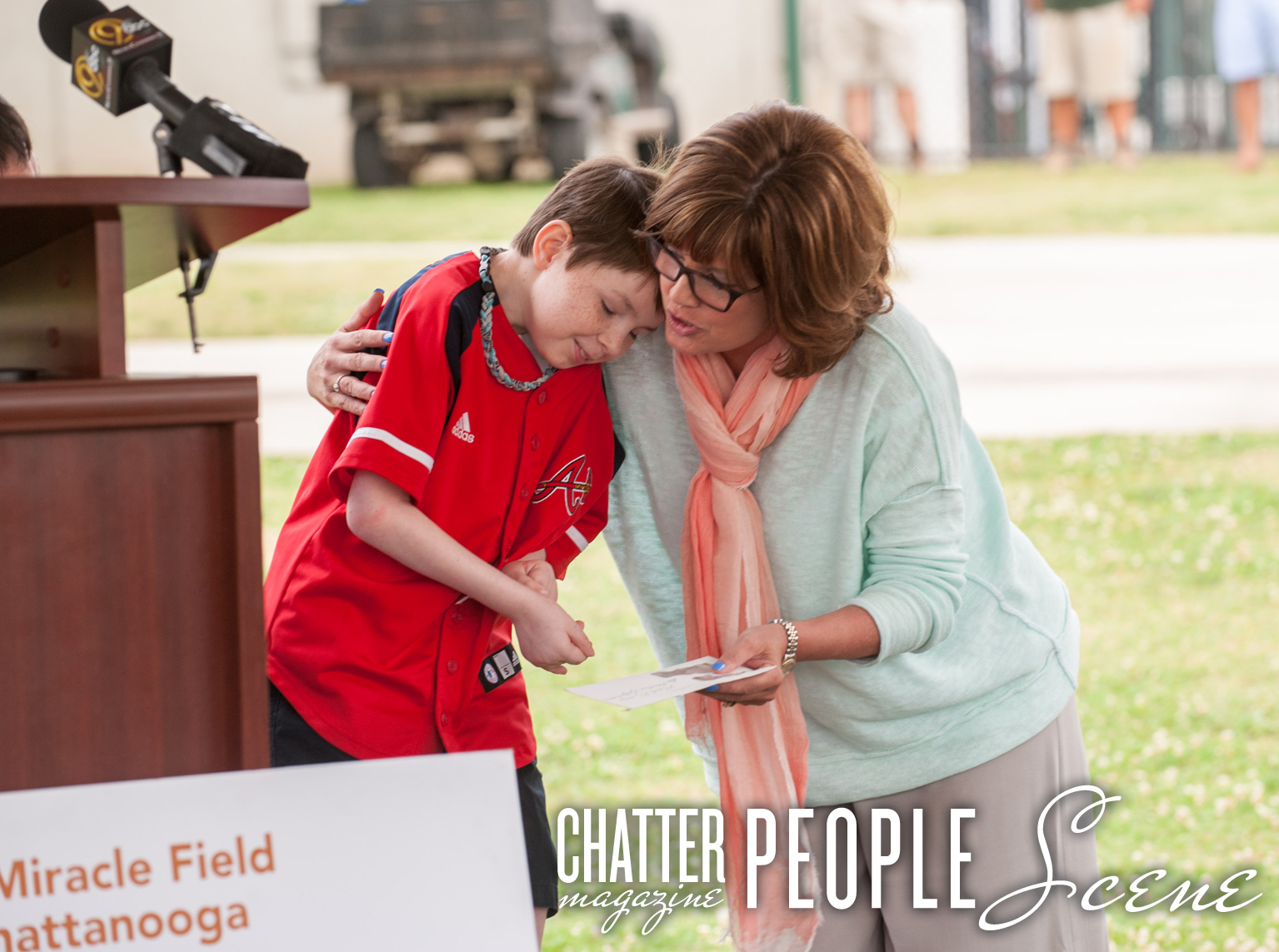 Kim Chapman gives Nash Norris a hug as he gives money to the Miracle Field.