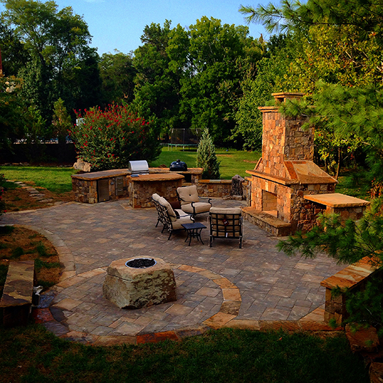 An outdoor fireplace by Southern Luxury