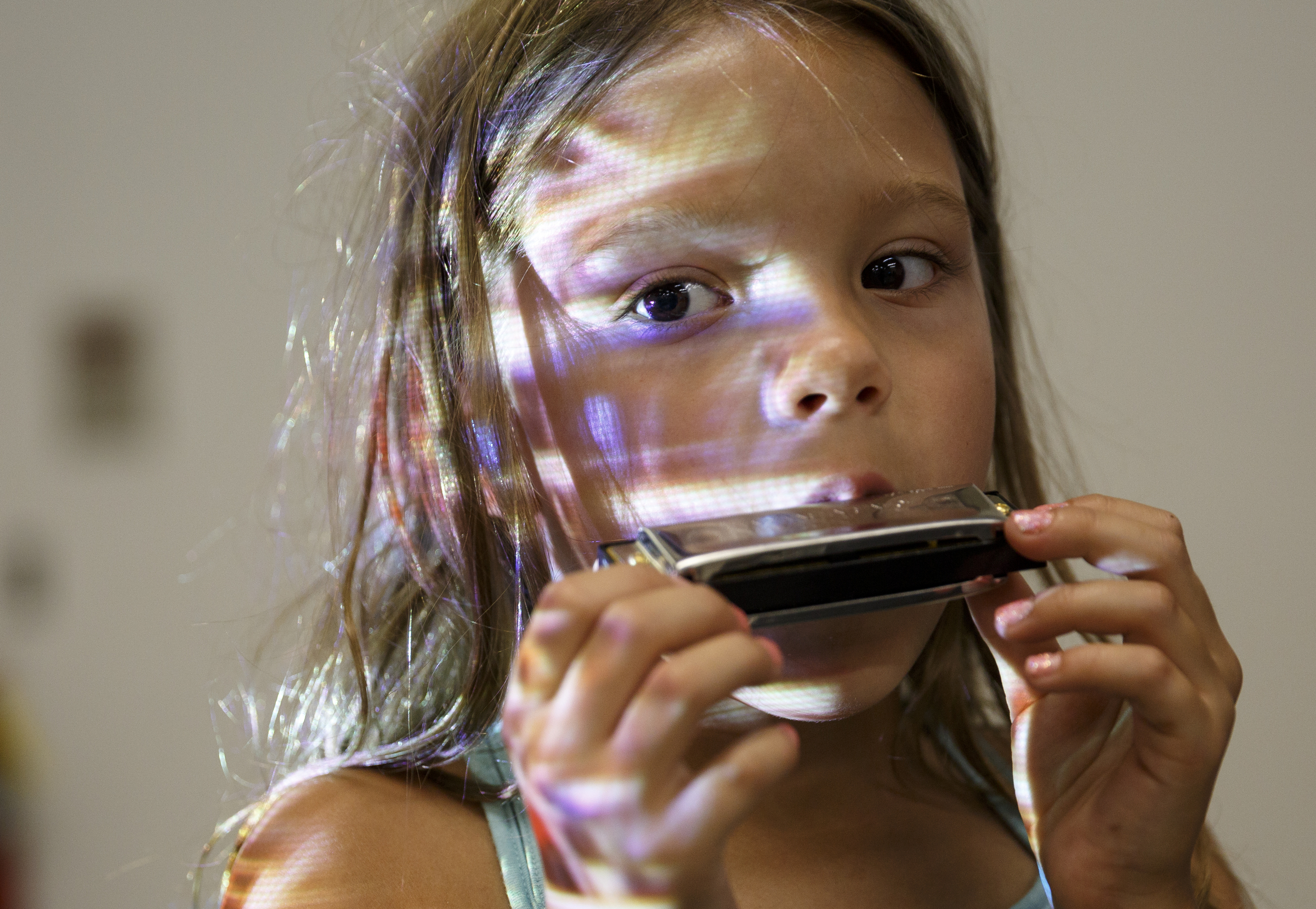 Ryleigh Curtis plays harmonica along with instructor Mark LaVoei as he gives a lesson via digital linkup from Burlington, Vermont, at the Chattanooga Public Library on Tuesday, June 21, 2016, in Chattanooga, Tenn. For Make Music Day, the library hosted interactive events that connected digitally to Burlington.