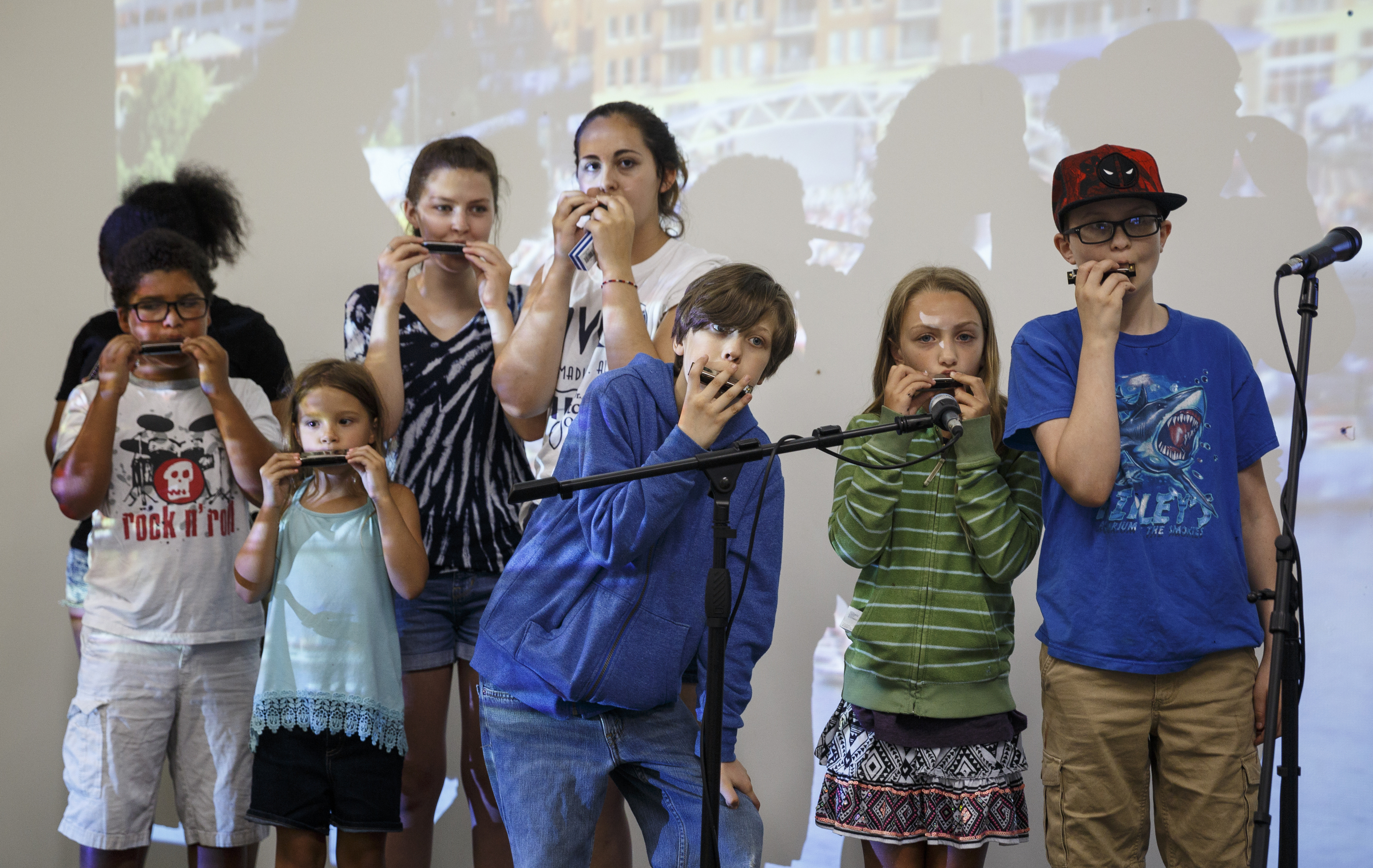 Students play harmonica along with instructor Mark LaVoei as he gives lessons via digital linkup from Burlington, Vermont, at the Chattanooga Public Library on Tuesday, June 21, 2016, in Chattanooga, Tenn. For Make Music Day, the library hosted interactive events that connected digitally to Burlington.