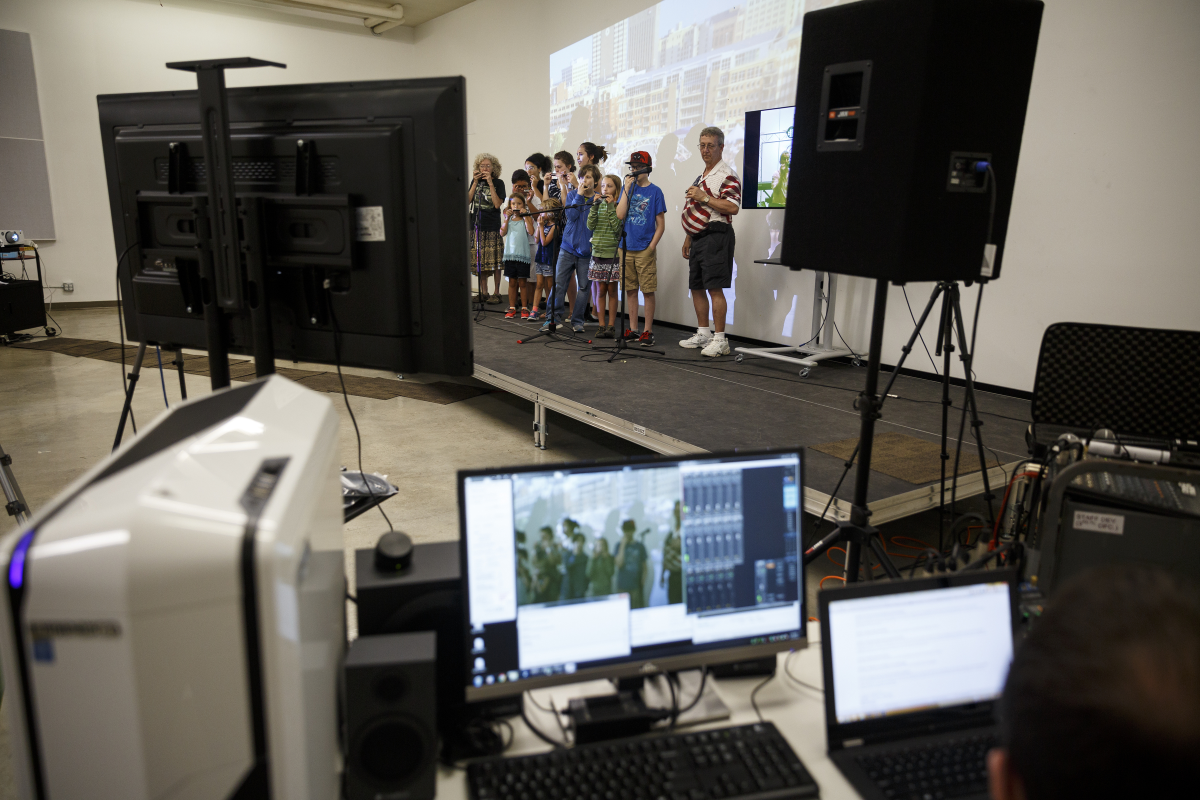 Students play harmonica along with instructor Mark LaVoei as he gives lessons via digital linkup from Burlington, Vermont, at the Chattanooga Public Library on Tuesday, June 21, 2016, in Chattanooga, Tenn. For Make Music Day, the library hosted interactive events that connected digitally to Burlington.