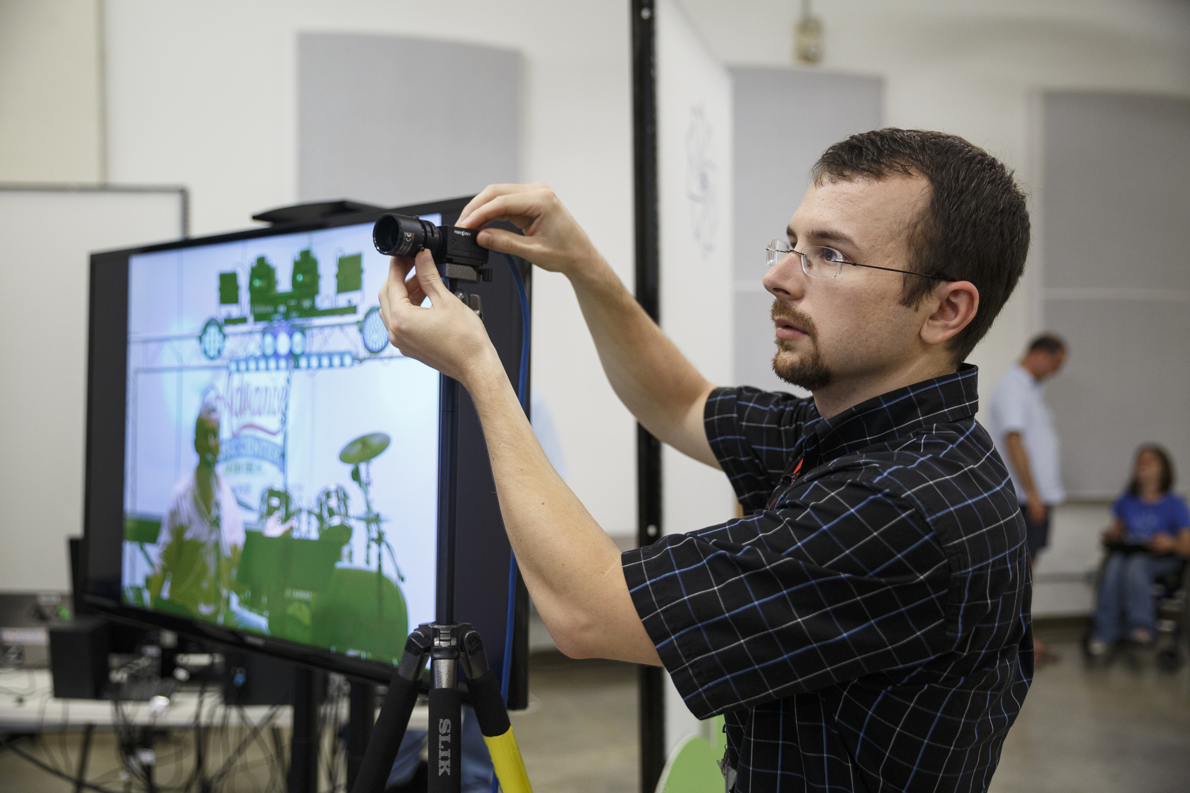 Rob Wichtman adjusts a camera that helps connect a music lesson from Burlington, Vermont, with students at the Chattanooga Public Library on Tuesday, June 21, 2016, in Chattanooga, Tenn. For Make Music Day, the library hosted interactive events that connected digitally to Burlington.