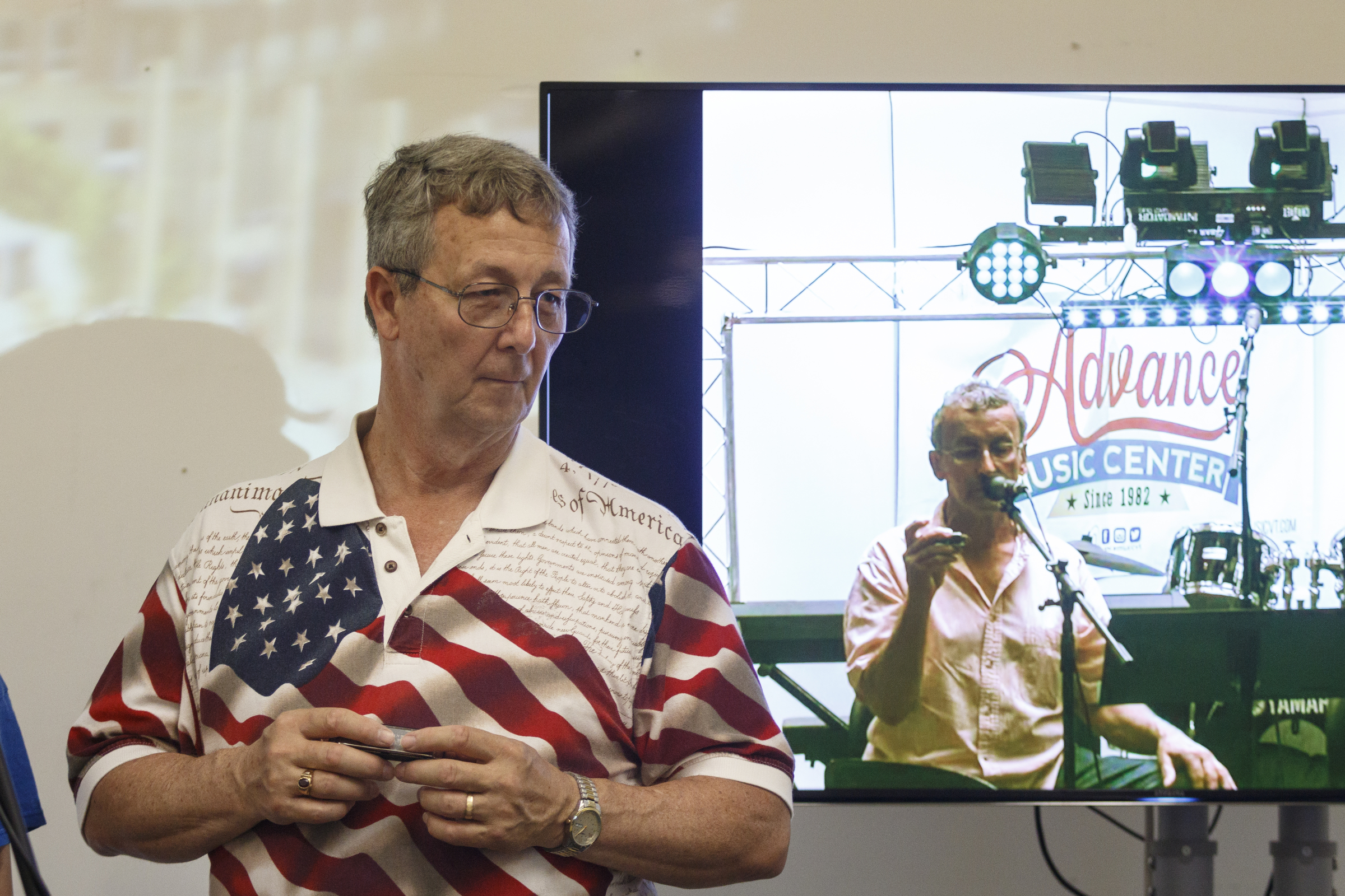 Ray Long, left, listens as musician Mark LaVoei gives a harmonica lesson on a screen from Burlington, Vermont, at the Chattanooga Public Library on Tuesday, June 21, 2016, in Chattanooga, Tenn. For Make Music Day, the library hosted interactive events that connected digitally to Burlington.
