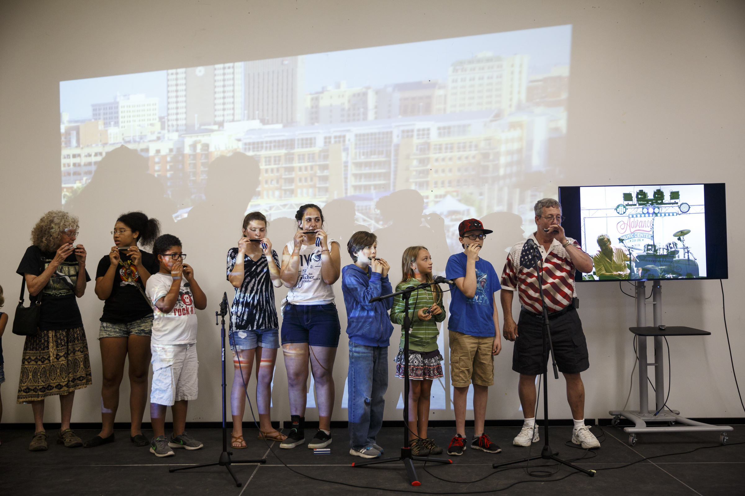 Students play harmonica along with instructor Mark LaVoei as he gives lessons via digital linkup from Burlington, Vermont, at the Chattanooga Public Library on Tuesday, June 21, 2016, in Chattanooga, Tenn. For Make Music Day, the library hosted interactive events that connected digitally to Burlington.