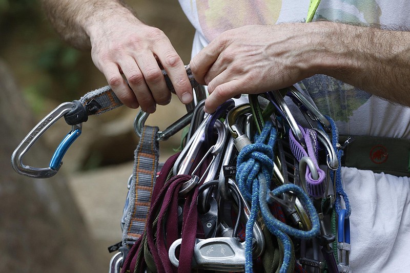 Staff Photo by Dan Henry / The Chattanooga Times Free Press- 6/23/16. Sam Latone prepares to teach Ana Jimenez (not pictured) how to set equipment on a simulated multi pitch climb at Sunset Rock atop Lookout Mountain on June 23, 2016. The pair used the training session in preparation for an upcoming trip to Colorado. 