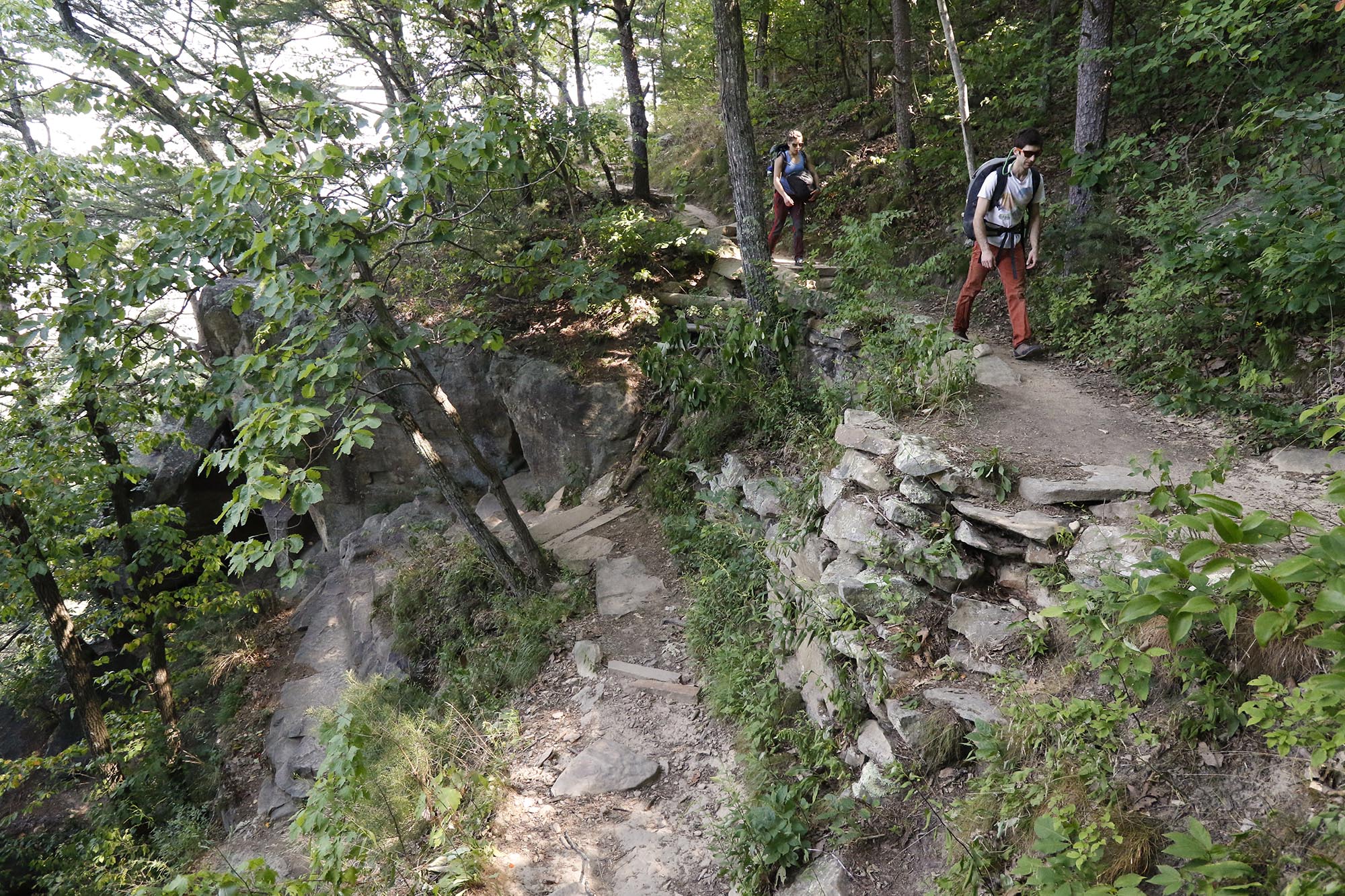 Staff Photo by Dan Henry / The Chattanooga Times Free Press- 6/23/16. Sam Latone and Ana Jimenez hike down to the bottom of Sunset Rock atop Lookout Mountain on June 23, 2016 to simulate a multi pitch climb in preparation for an upcoming trip to Colorado.