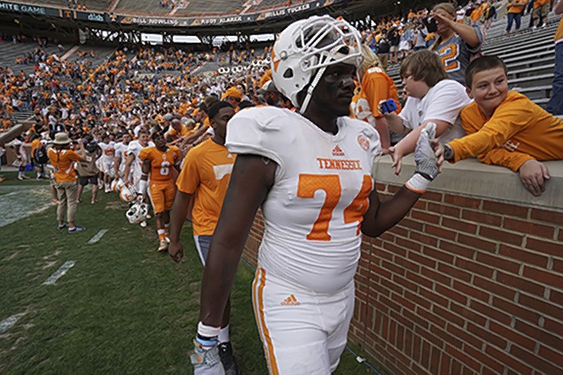 Staff Photo by Dan Henry / The Chattanooga Times Free Press- 4/25/15. The University of Tennessee's Dontavius Blair (74) gives fans high fives at the conclusion of the Dish Orange & White Game in Knoxville on Saturday, April 25, 2015. Final score was Orange 54, White 44.
