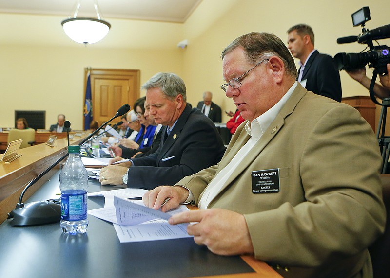 
              State Rep. Dan Hawkins, R-Wichita, along with the Kansas House Appropriations Committee, looks over their new school finance plan. Friday June 24, 2016, at the statehouse in Topeka, Kan. The bill would direct some profits from the sale of the Kansas Bioscience Authority to the State General Fund so that it may be used for school equity. (Chris Neal/The Topeka Capital-Journal via AP) MANDATORY CREDIT
            