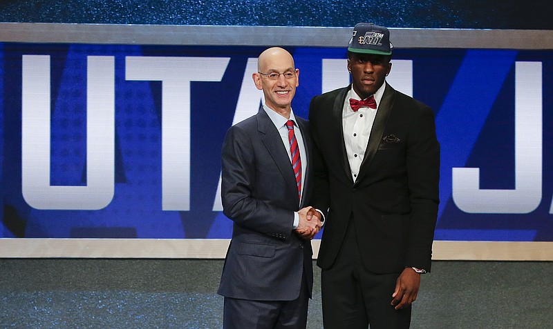 NBA Commissioner Adam Silver, left, poses with Taurean Prince after Prince was selected 12th overall by the Utah Jazz during the NBA basketball draft, Thursday, June 23, 2016, in New York. (AP Photo/Frank Franklin II)