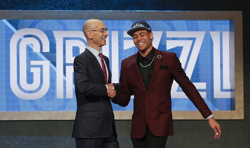 NBA Commissioner Adam Silver, left, congratulates Wade Baldwin IV after he was selected 17th overall by the Memphis Grizzlies during the NBA basketball draft, Thursday, June 23, 2016, in New York. (AP Photo/Frank Franklin II)