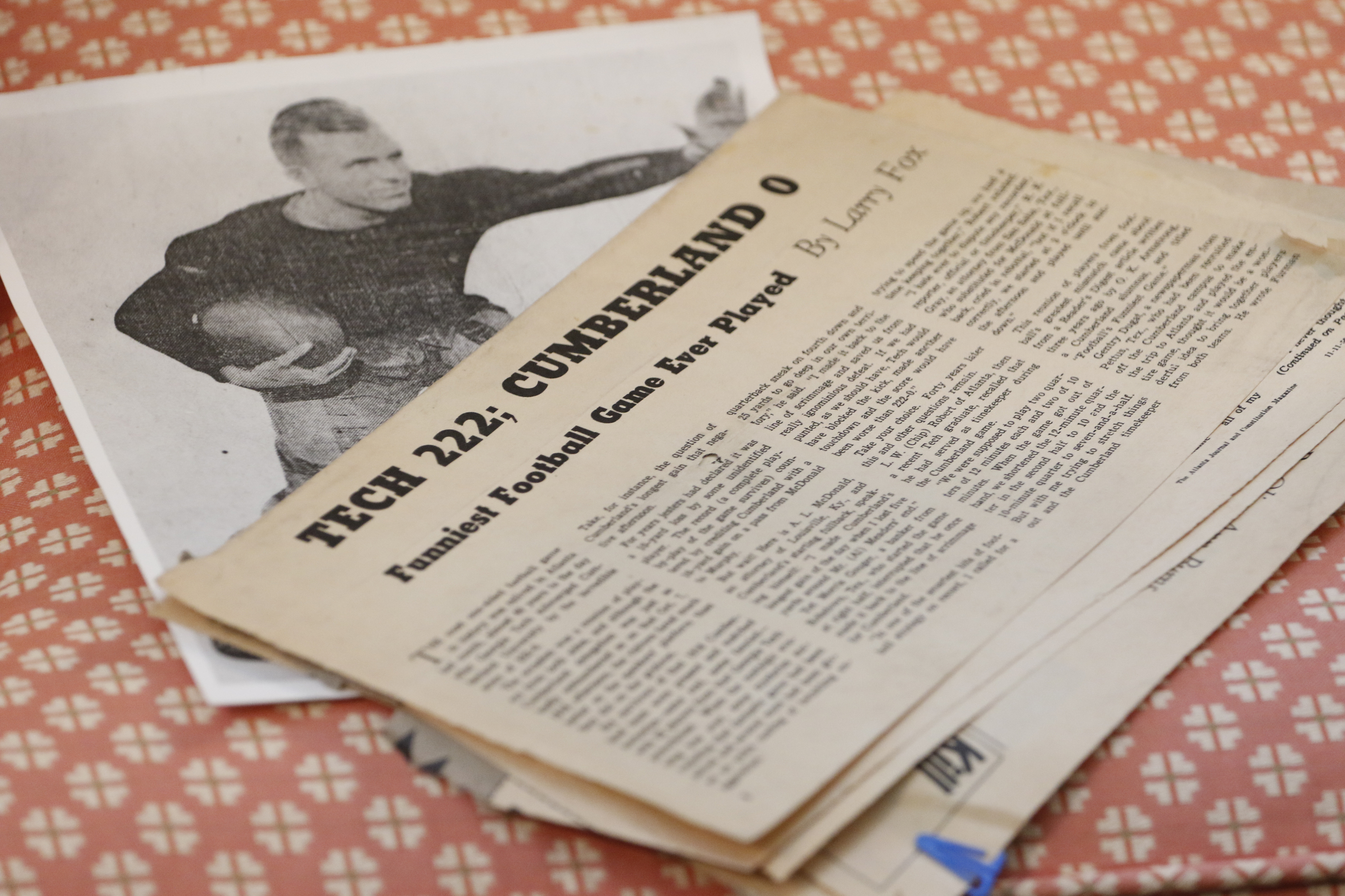 Staff Photo by Dan Henry / The Chattanooga Times Free Press- 6/20/16. Tad Johnston holds newspaper clippings from when his his father captained Georgia Tech's 1916 football team to beat Cumberland with a score of 222-0.