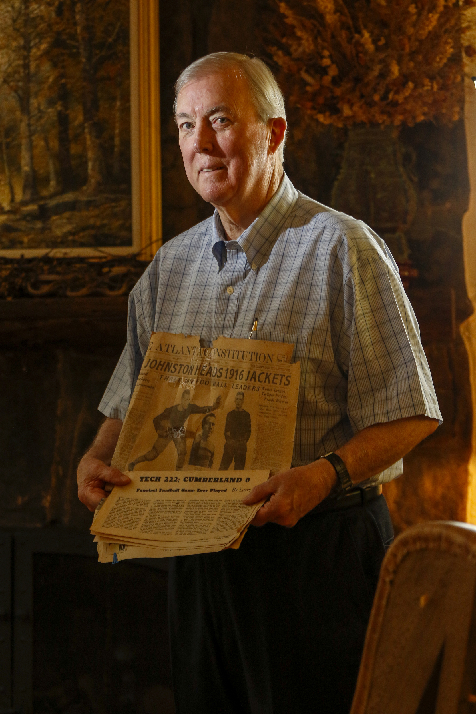 Staff Photo by Dan Henry / The Chattanooga Times Free Press- 6/20/16. Tad Johnston holds newspaper clippings from when his his father captained Georgia Tech's 1916 football team to beat Cumberland with a score of 222-0.