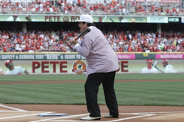 Former Cincinnati Reds manager Pete Rose hits a softball during