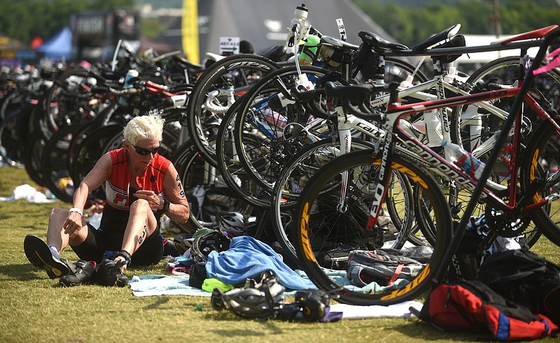 Becky Meagher changes shoes before beginning the running portion of the Waterfront Triathlon Sunday, June 26, 2016.