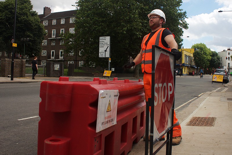 
              In this photo taken on Friday, June 24, 2016, Gabriel Ionut, a 24-year-old Romanian who works as a traffic marshal, stands by a signal at a construction site in London. Ionut is in the minority of the hundreds of thousands of foreign European workers who welcomed the British decision to leave the European Union as the majority of them are struggling with uncertainty about their future in Britain. (AP Photo, Pawel Kuczynski)
            