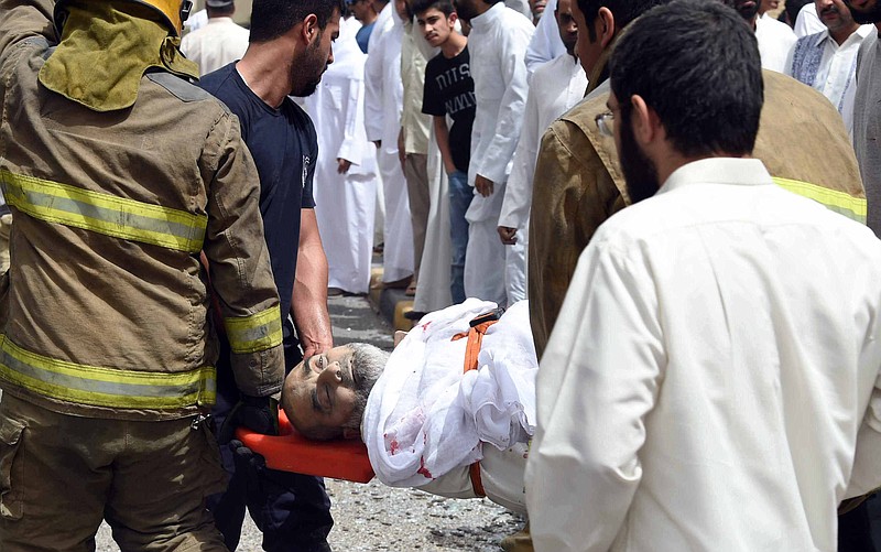
              FILE- In this Friday, June 26, 2015 file photo, a wounded man is helped moments after a deadly explosion claimed by the Islamic State group during Friday prayers at the Imam Sadiq Mosque in Kuwait City. A Kuwaiti mosque hit by an Islamic State suicide bomber a year ago has reopened, though people still fear sectarianism and future attacks. That’s in part due to the fact that regional tensions between Sunni and Shiite Muslims still ripple through the tiny, oil-rich Kuwait. (AP Photo, File)
            