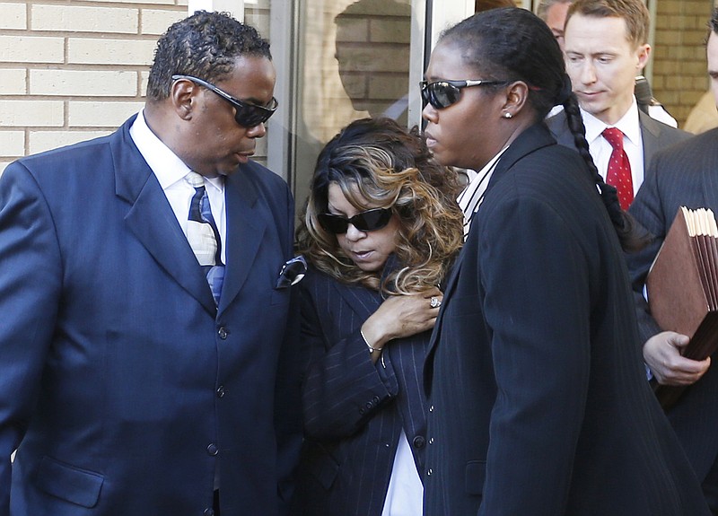 
              FILE - In this May 2, 2016, file photo, Tyka Nelson, center, the sister of Prince, leaves the Carver County Courthouse in Chaska, Minn., where a judge confirmed the appointment of a special administrator to oversee the settlement of the late entertainer's estate. A hearing will be held Monday, June 27, 2016, in suburban Minneapolis about the procedures for determining who stands to inherit part of Prince's estate. Prince died in April of an accidental drug overdose, and no will has been found. (AP Photo/Jim Mone, File)
            