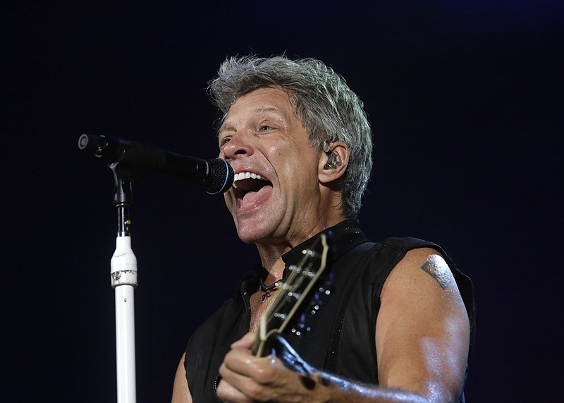 
              FILE - In this Sept. 11, 2015 file photo, Bon Jovi's lead singer Jon Bon Jovi performs during their "Bon Jovi Live!" concert at Gelora Bung Karno Stadium in Jakarta, Indonesia, on their Asia tour. A New Jersey woman battling lung cancer has received an unforgettable surprise from one of the state's most famous rockers, Bon Jovi. Rosie Skripkunis says her mother, Carol Cesario, is a lifelong fan of Bon Jovi and has always wanted to meet him. Last month, Skripkunis shared a sign on social media asking the singer to visit her mother. Bon Jovi surprised Cesario at his Toms River restaurant on Saturday, June 25, 2016, with an autographed guitar and a kiss. (AP Photo/Tatan Syuflana, File)
            