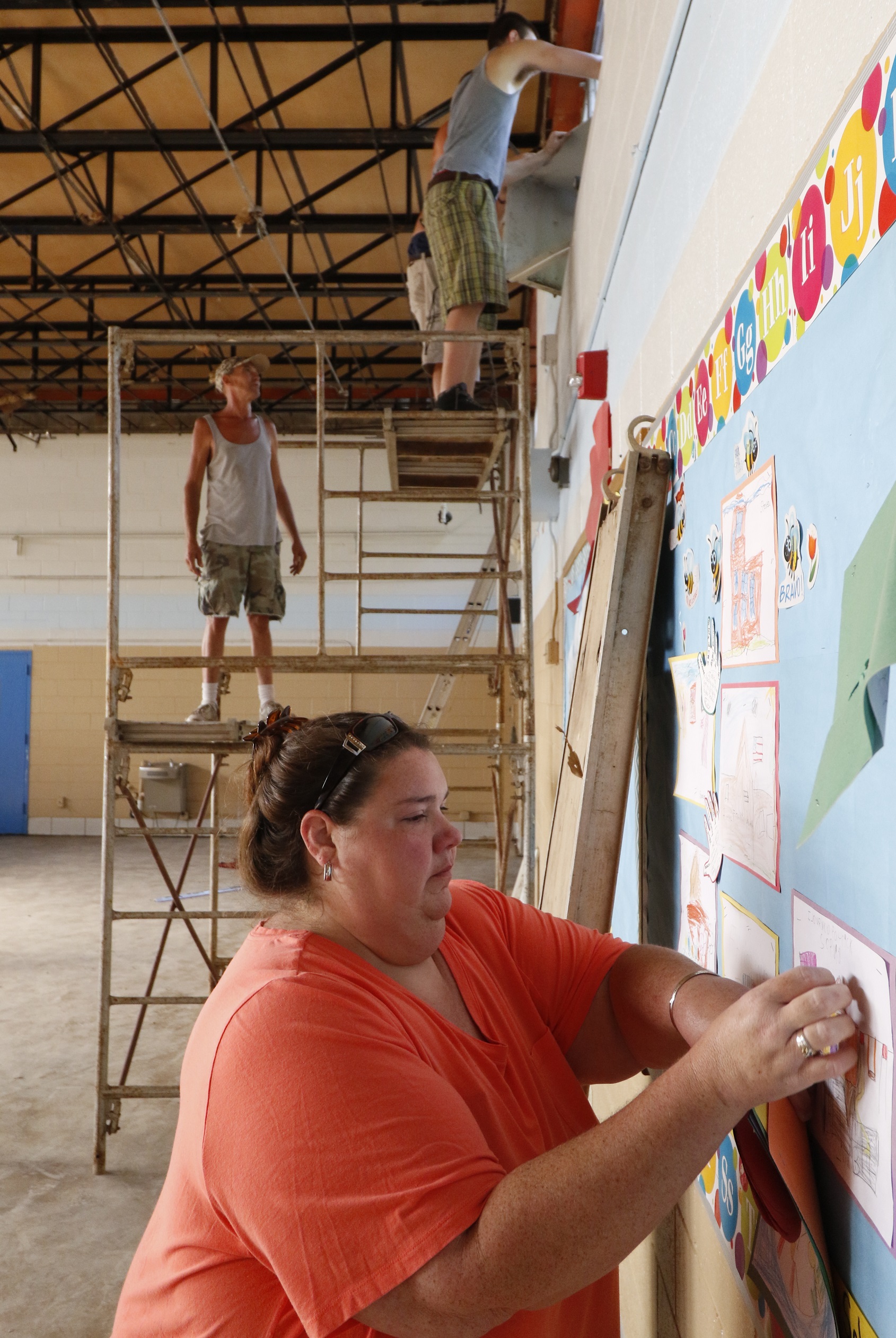 Stephanie Alexander becomes emotional while taking children's artwork off the walls hours before demolition begins. The Alexander family originally donated the land and has since had five generations go through the school.