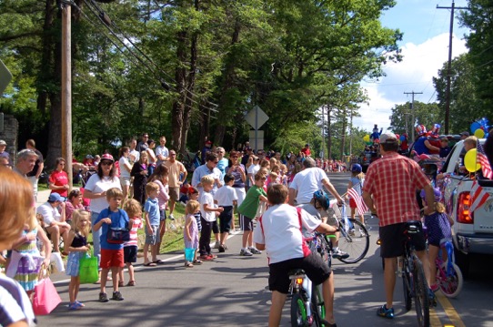 Residents and visitors line the streets for a previous year's Fourth of July parade.