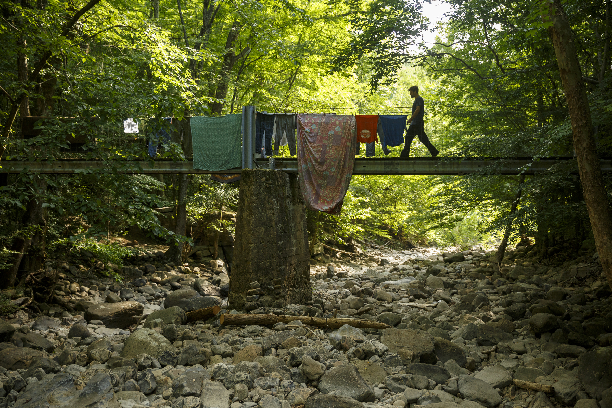 Patrick Ironwood crosses a coal bridge which serves as an entrance to the Sequatchie Valley Institute on Wednesday, June 22, 2016, in Whitwell, Tenn. The nonprofit has completed a new pair of self-guided nature trails which are available to the public on the weekends.