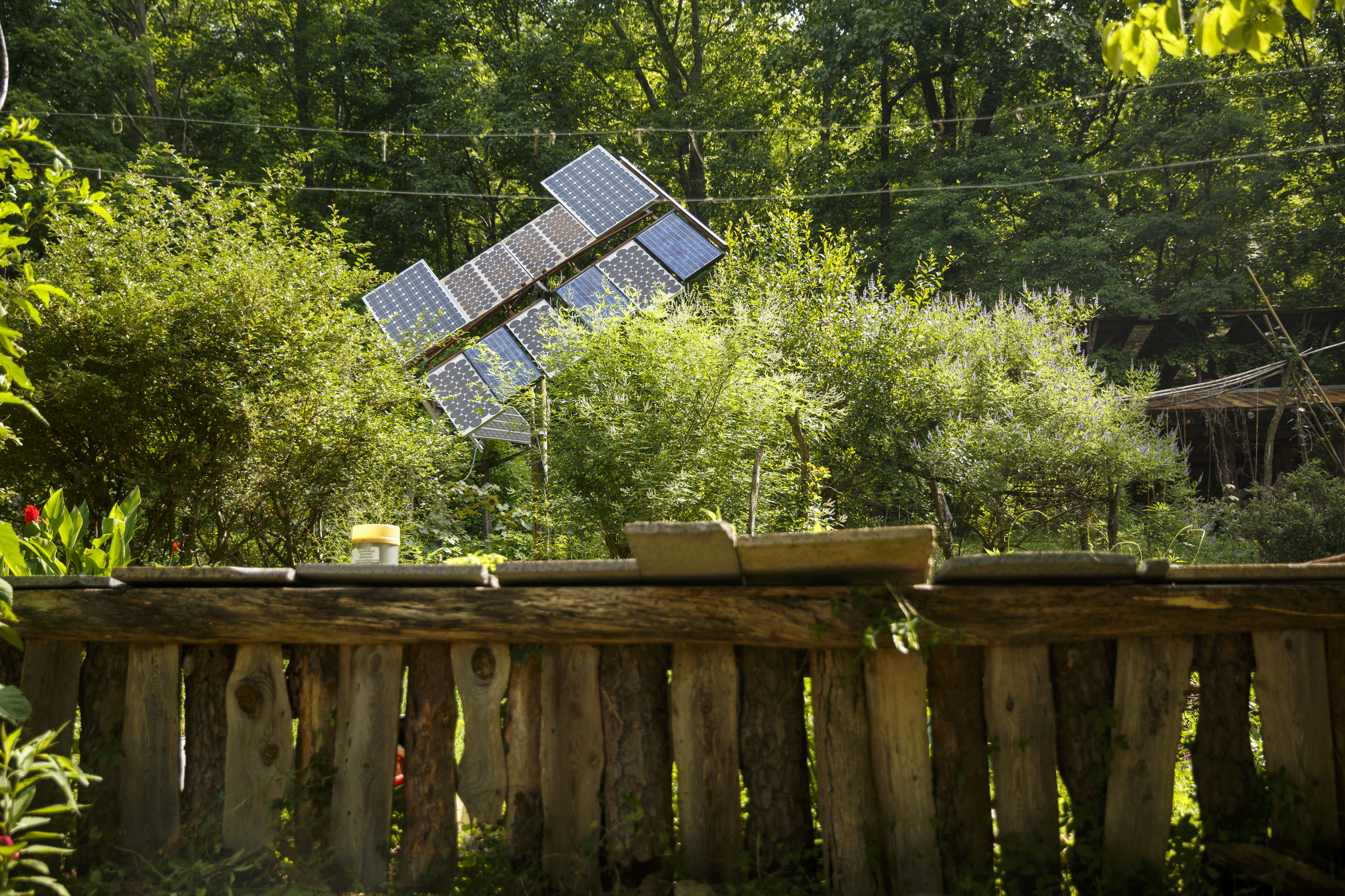 Solar panels peek from behind a garden at the Sequatchie Valley Institute, which is off the grid, on Wednesday, June 22, 2016, in Whitwell, Tenn. The nonprofit has completed a new pair of self-guided nature trails which are available to the public on the weekends.