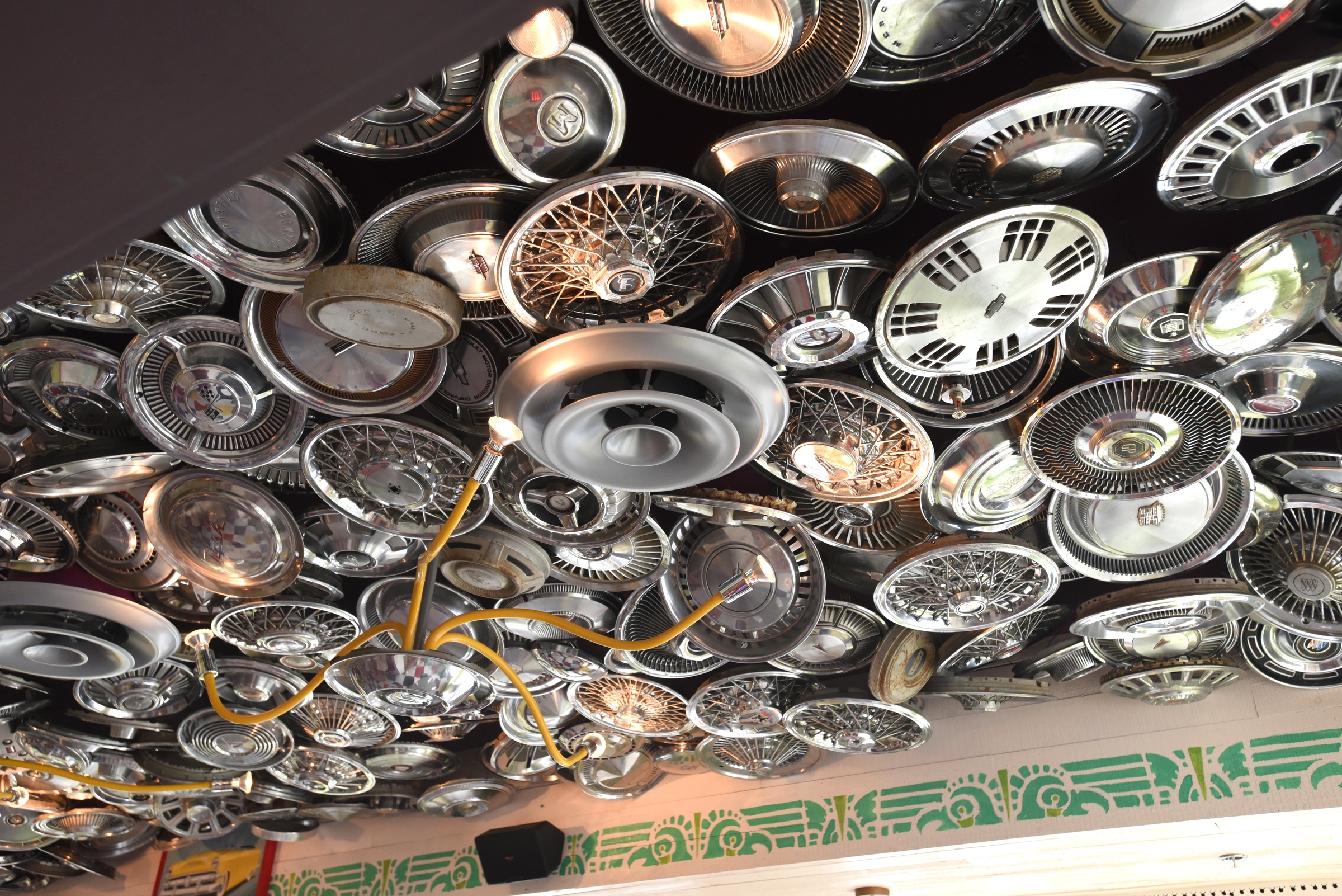 Hubcaps line the ceiling in a dining area Monday, June 27, 2016 at Chuy's on Gunbarrel Road.
