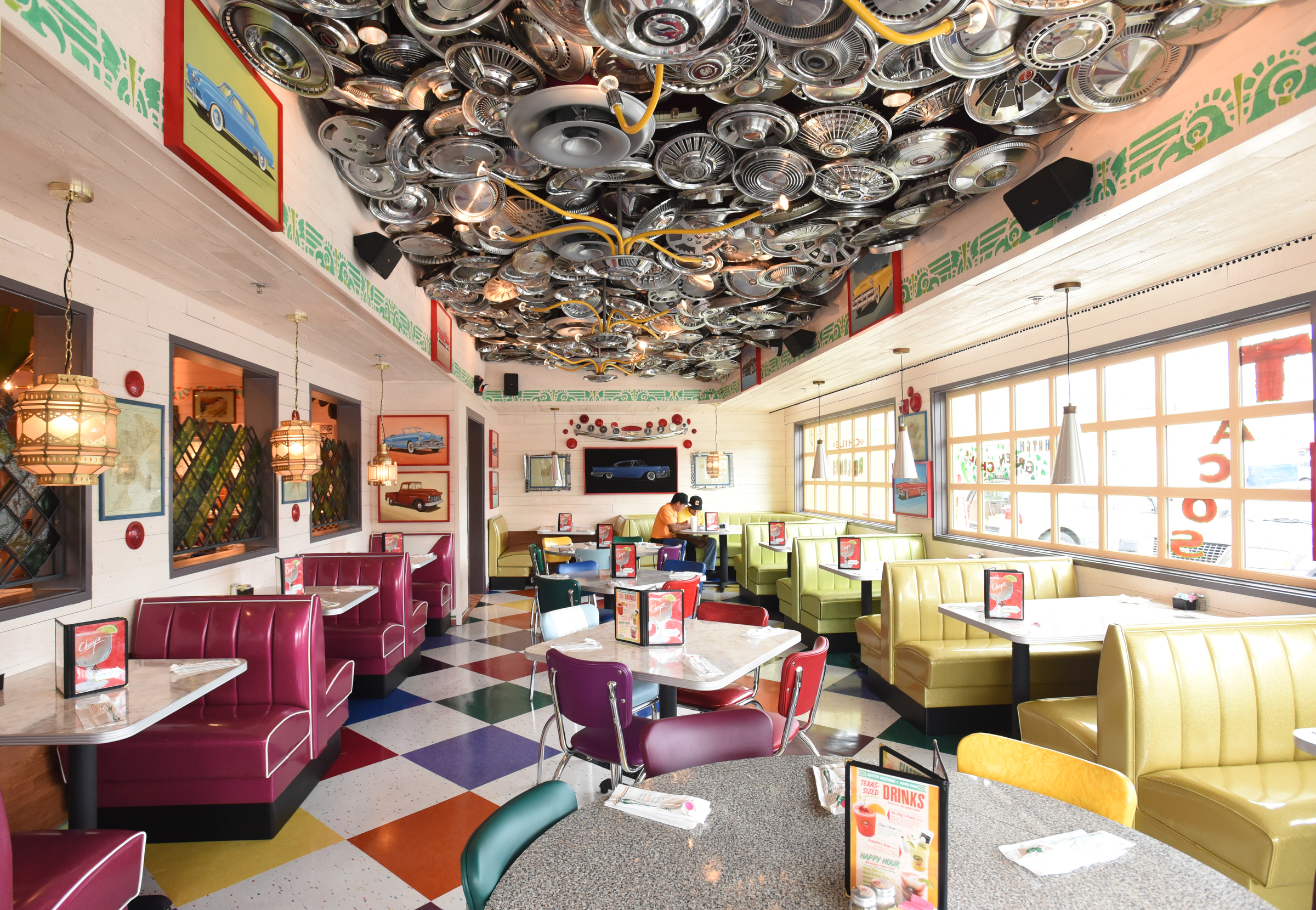 Hubcaps line the ceiling in a dining area Monday, June 27, 2016 at Chuy's on Gunbarrel Road.