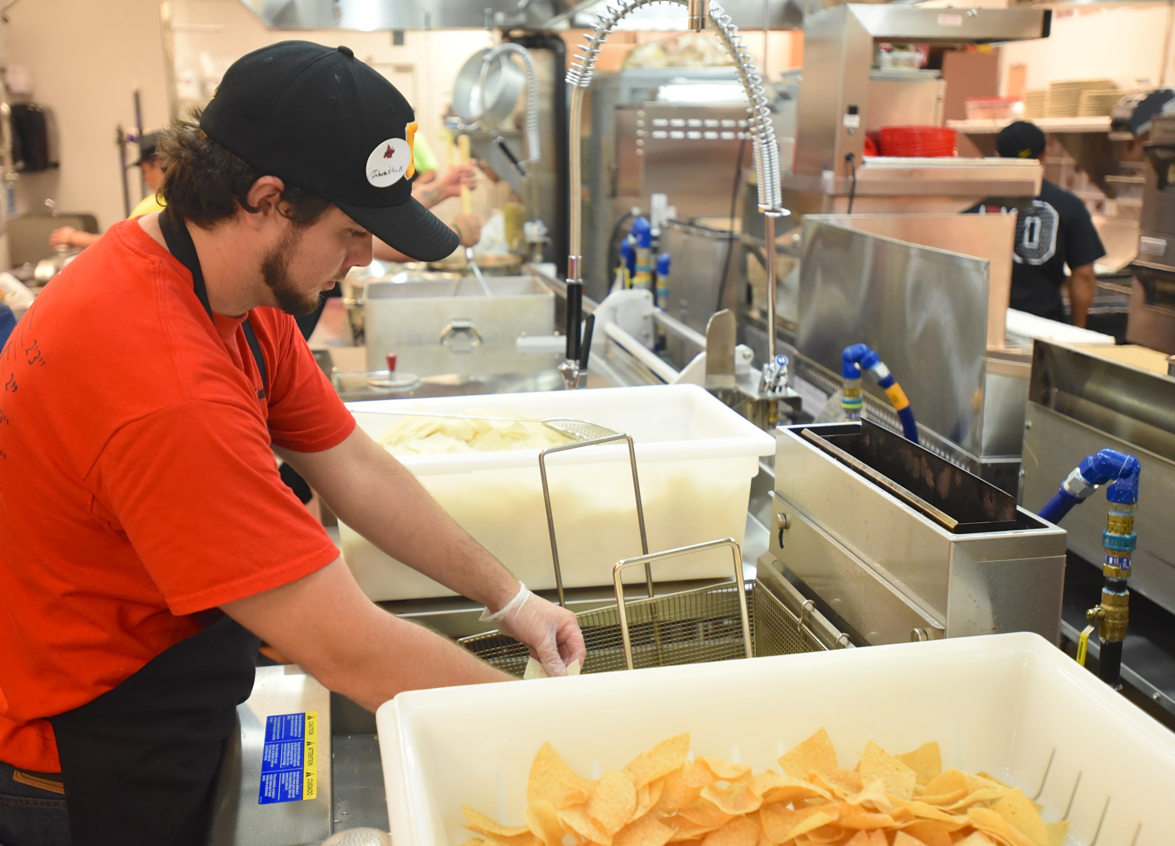 Jonathan Grayson fries tortilla chips Monday, June 27, 2016 at Chuy's on Gunbarrel Road.
