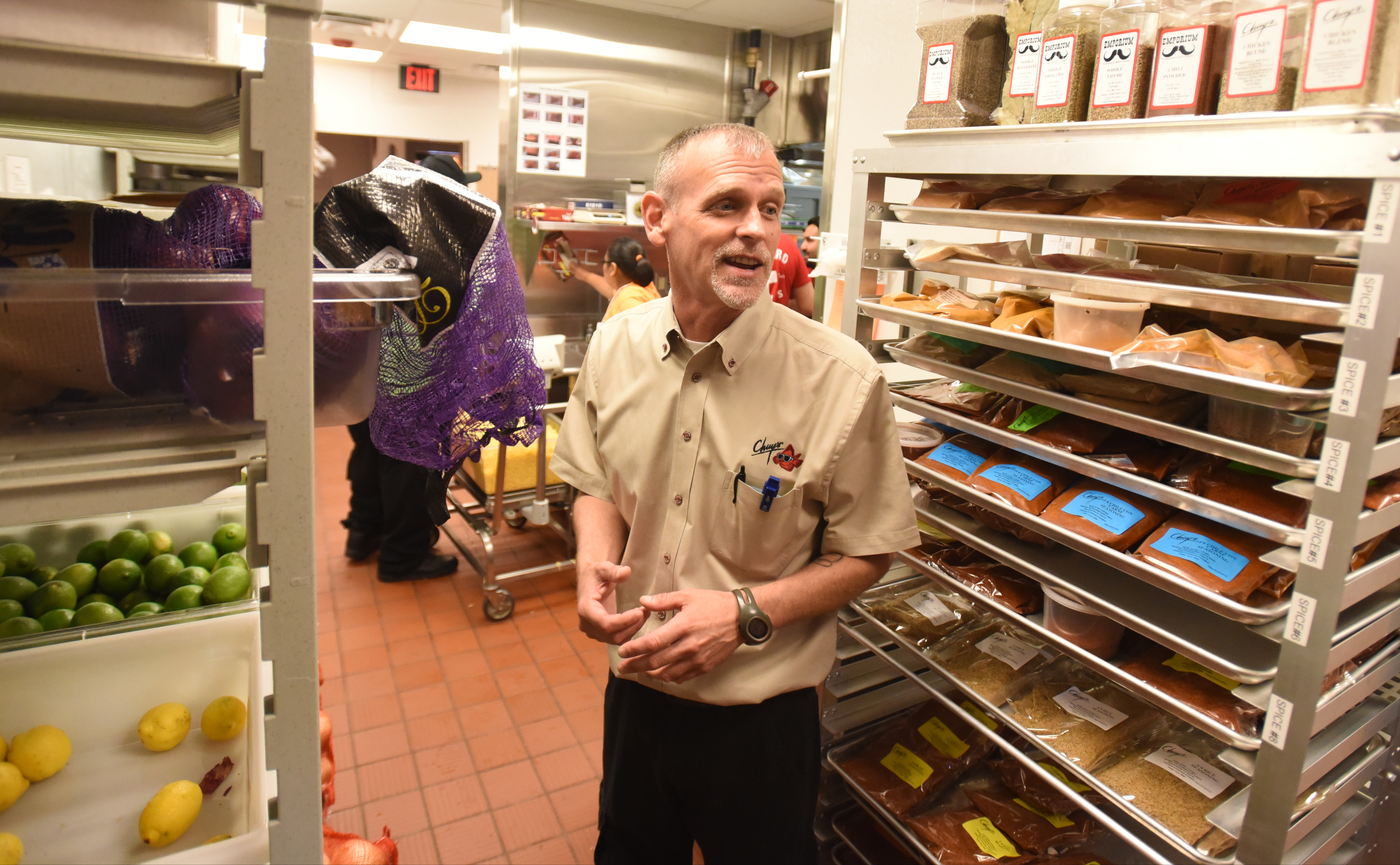 Kitchen training coordinator Brian Wolfe talks in the kitchen Monday, June 27, 2016 at Chuy's on Gunbarrel Road.