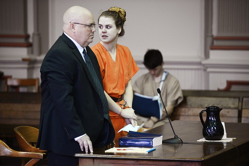 
              Emile Weaver, center, standing next to her attorney Aaron Miller, left, looks toward the gallery while addressing the court during her sentencing Monday, June 27, 2016, in Muskingum County Common Pleas Court in Zanesville, Ohio. Muskingum County Common Pleas Judge Mark Fleegle sentenced Weaver to life in prison without parole for disposing  of her newborn baby in a trash bin outside the Delta Gamma Theta sorority house on campus. Weaver, 21, was found guilty by a jury last month of aggravated murder, abuse of a corpse and tampering with evidence.  (Chris Crook/Times Recorder via AP, Pool)
            