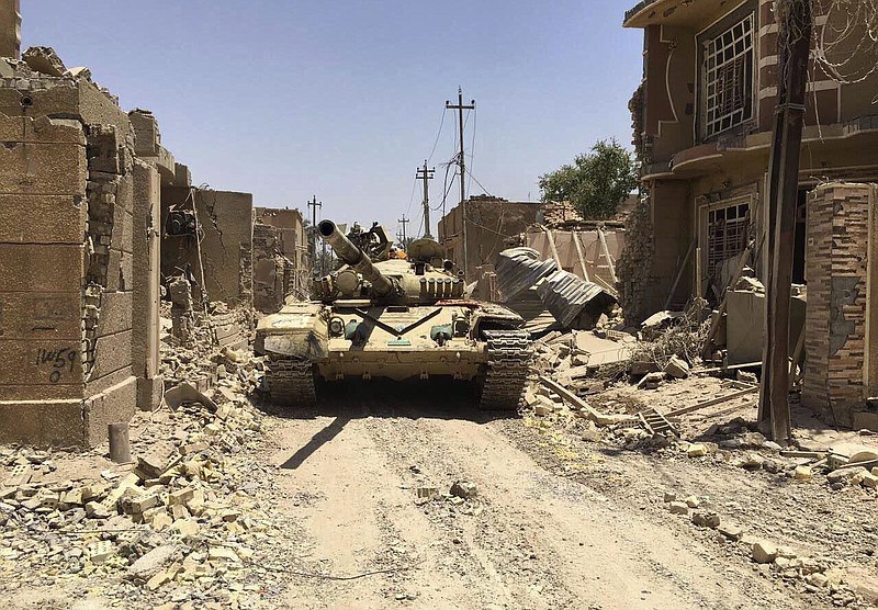 
              Iraqi security forces in al-Julan neighborhood after defeating Islamic State militants in Fallujah, Iraq, Sunday, June 26, 2016. A senior Iraqi commander said the city of Fallujah was "fully liberated" from Islamic State militants on Sunday, after a more than monthlong military operation. (AP Photo)
            