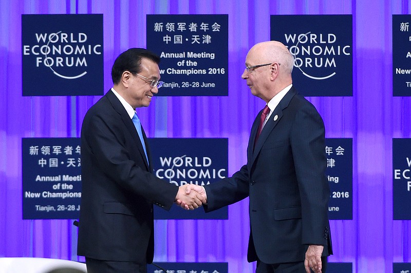 
              Founder and Executive Chairman of the World Economic Forum Klaus Schwab, right, shakes hands with Chinese Premier Li Keqiang during the World Economic Forum in Tianjin, China Monday, June 27, 2016. (Wang Zhao/Pool Photo via AP)
            