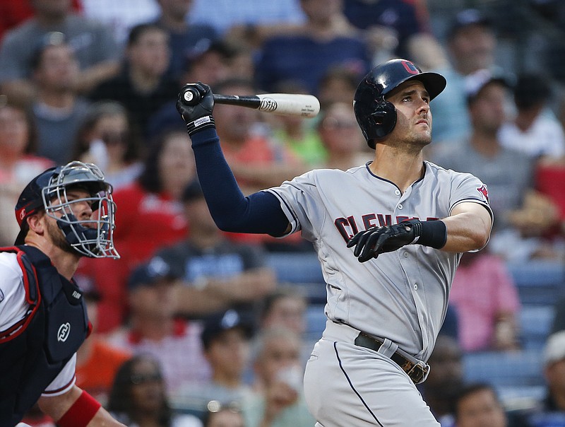 Cleveland Indians' Lonnie Chisenhall (8) and Atlanta Braves catcher Tyler Flowers, left, follow the flight of a three-run home run in the fourth inning of a baseball game Monday, June 27, 2016, in Atlanta.