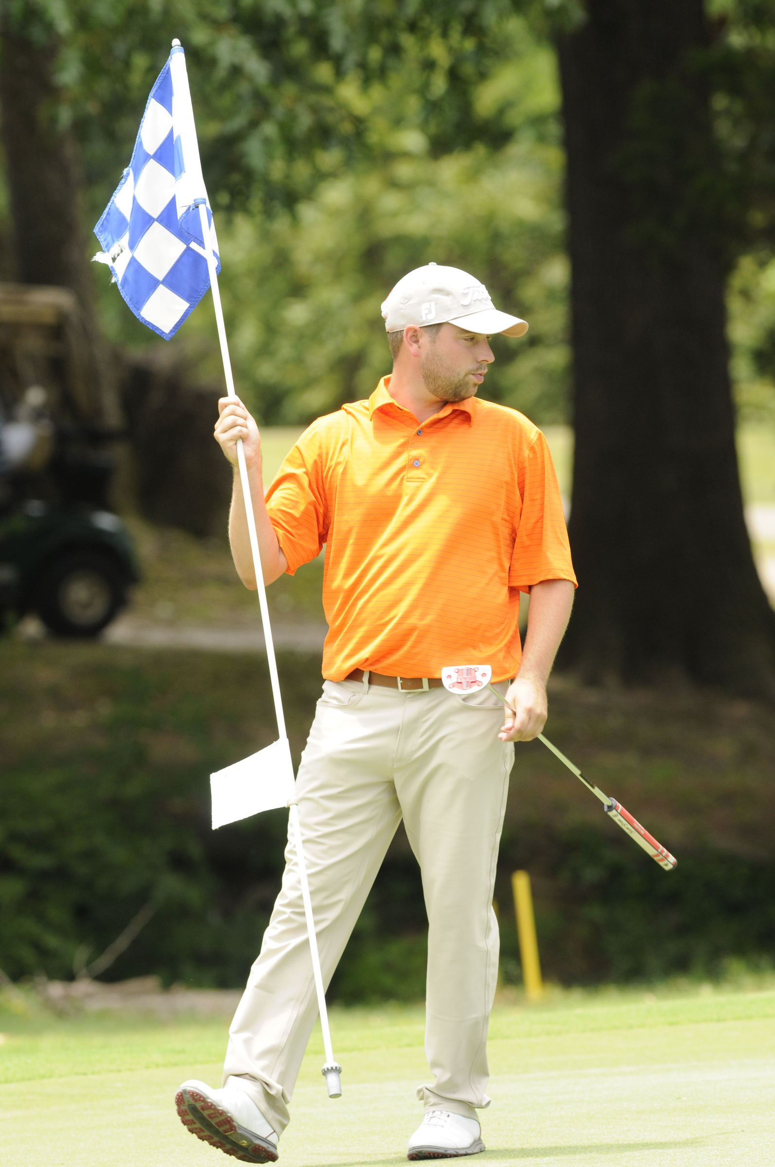 Casey Flenniken pulls the flag at No. 17, on his way to a 6-under-par tournament win at Creeks Bend Golf Club in Hixson on Tuesday.