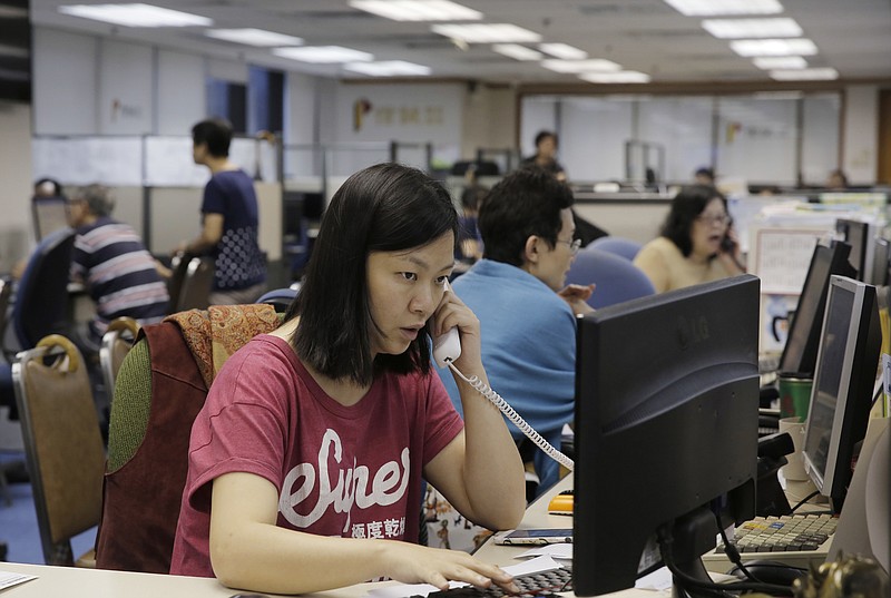 
              A broker talks on phone as she monitors stock prices at a brokerage firm in Hong Kong, Tuesday, June 28, 2016. Most Asian stock benchmarks slipped on Tuesday as Britain's vote to quit the European Union and its messy aftermath continued to reverberate throughout global financial markets. (AP Photo/Kin Cheung)
            