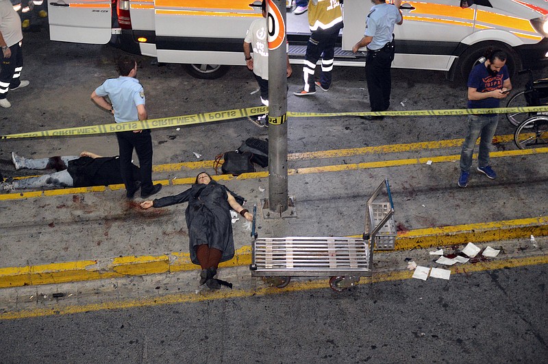 
              EDS NOTE: GRAPHIC CONTENT- Turkish rescue and security officers work near an entrance of Istanbul's Ataturk airport, Tuesday, June 28, 2016. Suspected Islamic State group extremists have hit the international terminal of Istanbul's Ataturk airport, killing dozens of people and wounding many others, Turkish officials said Tuesday. Turkish authorities have banned distribution of images relating to the Ataturk airport attack within Turkey. (IHA via AP) TURKEY OUT
            