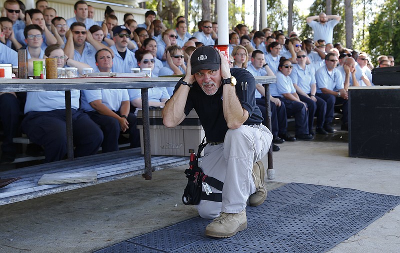 
              In this Tuesday, June 7, 2016, photo, Transportation Security Administration instructor Larry Colburn covers his ears as he prepares to set off an explosive device during a lecture to airport security officer candidates at the Federal Law Enforcement Training Center in Brunswick, Ga. Short-staffed and often criticized, the TSA aims to improve training for airport screeners. (AP Photo/John Bazemore)
            