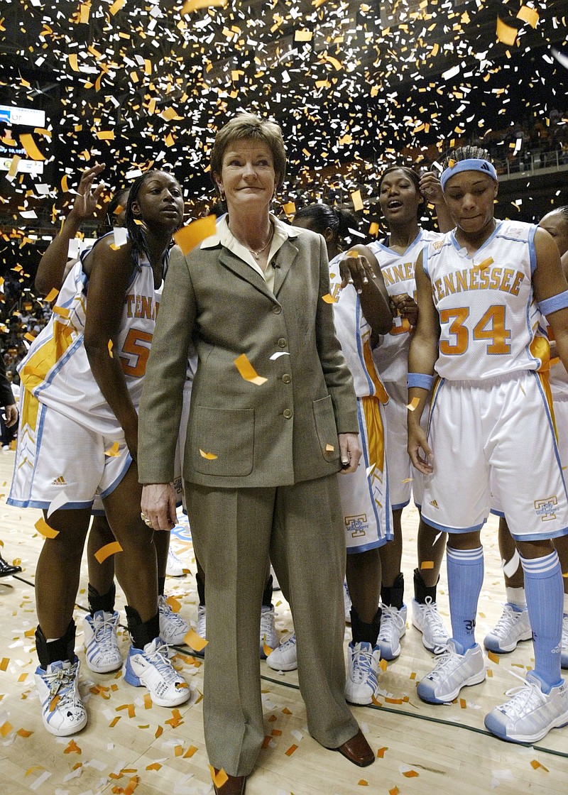 In this Jan. 14, 2003, file photo, Tennessee head coach Pat Summitt, center, smiles as she stands with her team after defeating DePaul, 76-57, to get her 800th career win, in Knoxville, Tenn. Tye'sha Fluke is at left, Courtney McDaniel (34), right, and Ashley Robinson, second from right. (AP Photo/Wade Payne, FIle)