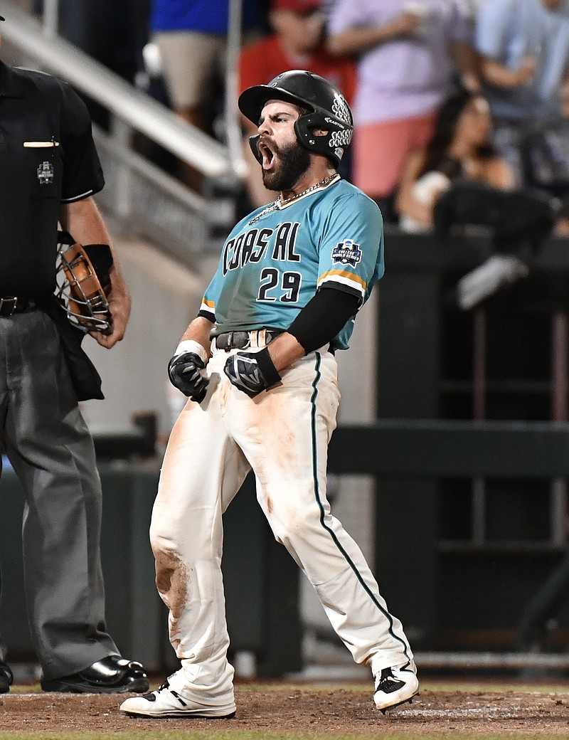 
              Coastal Carolina's Anthony Marks reacts to scoring on a Connor Owings single against Arizona in the eighth inning in Game 2 of the NCAA Men's College World Series finals baseball game in Omaha, Neb., Tuesday, June 28, 2016. (AP Photo/Ted Kirk)
            